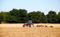 Tractor and harrow cultivating the soil Royalty Free Stock Photo