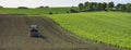 Tractor with harrow on field in beautiful countryside of south limburg in the netherlands on sunny day in the fall Royalty Free Stock Photo