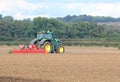 Tractor harrowing field. Royalty Free Stock Photo