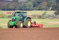 Tractor harrowing field.