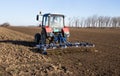 Tractor harrowing land in springtime