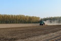 Tractor harrowing rice field, Lomellina (Italy)