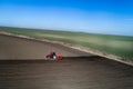 Tractor harrowing soil in spring