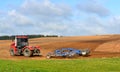 Tractor harrows the ground in the village