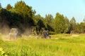 Tractor with harrows on rural dusty road after work Royalty Free Stock Photo