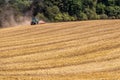 Tractor harvester working in wheat field in summer time
