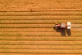 Tractor hauling a Two disc Fertilizer spreader in a large field Royalty Free Stock Photo