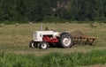 Tractor in hay field Royalty Free Stock Photo