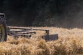 tractor haying straw on summer corn field