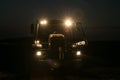 Tractor with headlights on at night time