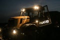 Tractor with headlights on at night time