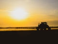 tractor with the help of a sprayer liquid fertilizers on young wheat in the field Royalty Free Stock Photo