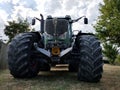 tractor with huge wheels against the sky