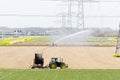 Tractor with irrigation equipment watering crops Royalty Free Stock Photo