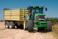 Tractor John Deere on harvested field Royalty Free Stock Photo