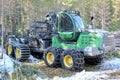 Tractor with large chained wheels parked in a rural setting