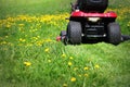 Tractor lawn mower cutting the grass in springtime Royalty Free Stock Photo