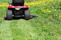 Tractor lawn mower cutting the grass in springtime Royalty Free Stock Photo