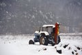 Tractor left in the middle of a snowy field