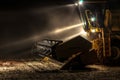 Tractor with lights on at night after the soybean harvest