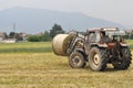 Tractor loading hay bale in Turin