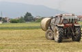 Tractor loading hay bale in Turin