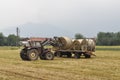 Tractor loading hay bale in Turin