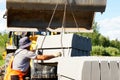 Tractor loads concrete blocks