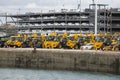 Tractor and luxury cars await export from docks UK