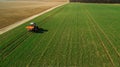 Tractor makes fertilizer on the field. Aerial survey