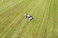 Tractor makes hay bales on a field