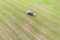 Tractor makes hay bales on a field