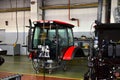 Tractor Manufacture work. Assembly line inside the agricultural machinery factory. Installation of parts on the tractor body