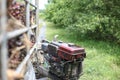 A tractor mechanical operates by a worker to pick up palm oil fruits near palm plantation