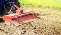 Tractor with milling machine loosens, grinds and mixes ground. Field preparation for new crop planting. Cultivation equipment.