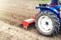 Tractor with milling machine loosens, grinds and mixes soil. Cultivation technology equipment. Loosening the surface, cultivating