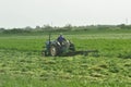 Tractor with mower in the field of alfalfa Royalty Free Stock Photo