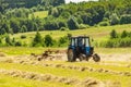 tractor with mower to mow grass in meadows . Tractor cut hay from alfalfa. Preparation of animal feed for rabbits, cows Royalty Free Stock Photo