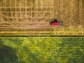 Tractor mowing agricultural field. Aerial view. Cultivating field. Royalty Free Stock Photo