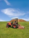 Tractor mowing green field