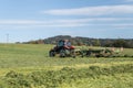 Tractor mows a meadow in the Bavarian Forest, Germany