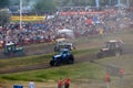 Tractor mud racing on off road terrain. Races on a cross-country terrain on BIZON Truck Show. Royalty Free Stock Photo