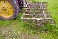 Tractor with old agriculture rake machinery in farm Royalty Free Stock Photo