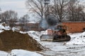 The tractor operator starts the bulldozer