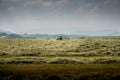 Tractor parked on a swathed farm field Royalty Free Stock Photo