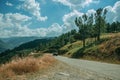 Tractor passing through roadway on hilly landscape