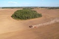 Tractor with Plough on Plowed. Ploughing and Soil Tillage. Agricultural Tractor on Cultivation Field for Sowing Seeds. Tractor Royalty Free Stock Photo