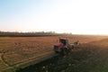 Tractor with Plough on Plowed. Ploughing and Soil Tillage. Agricultural Tractor on Cultivation Field for Sowing Seeds. Tractor Royalty Free Stock Photo