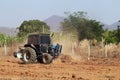 Tractor with Plougher and Grader Working