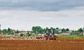 The tractor ploughs an agricultural field